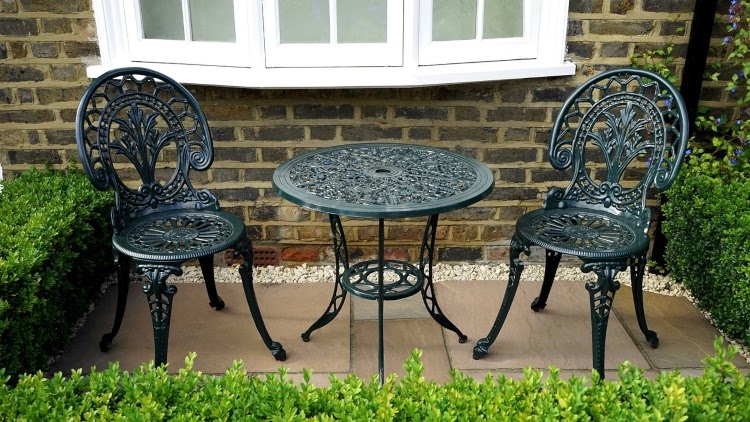 black, wrought iron, outdoor dining set for two on small patio
